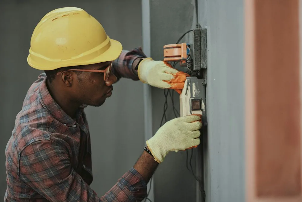 Appliance technician fixing refrigerator in Aylmer home